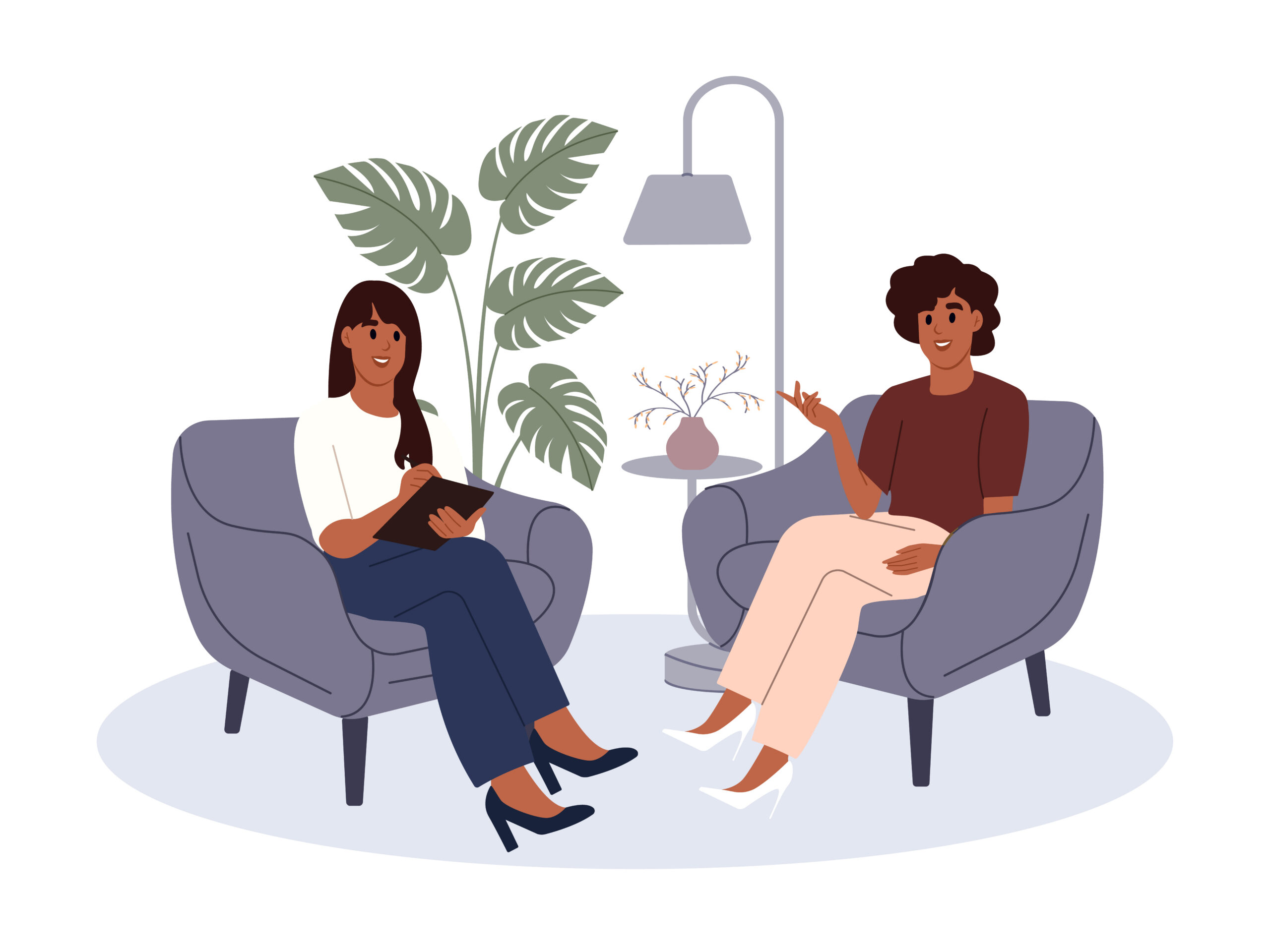 Two people sitting and talking in chairs.